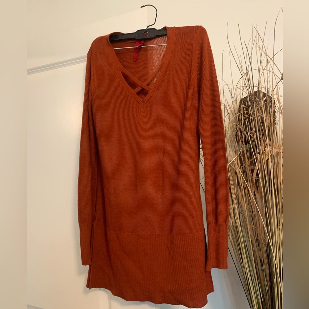 Rust color sweater with slit on each side of sweater